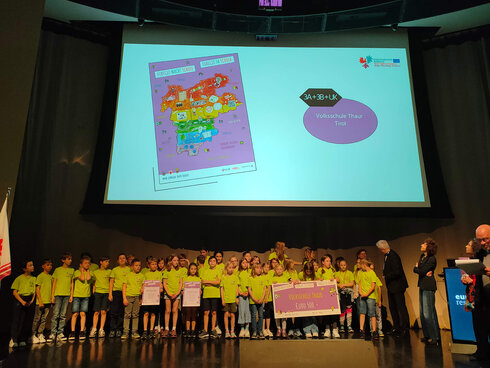 Eine Schulklasse nimmt ihren Gewinn entgegen.
